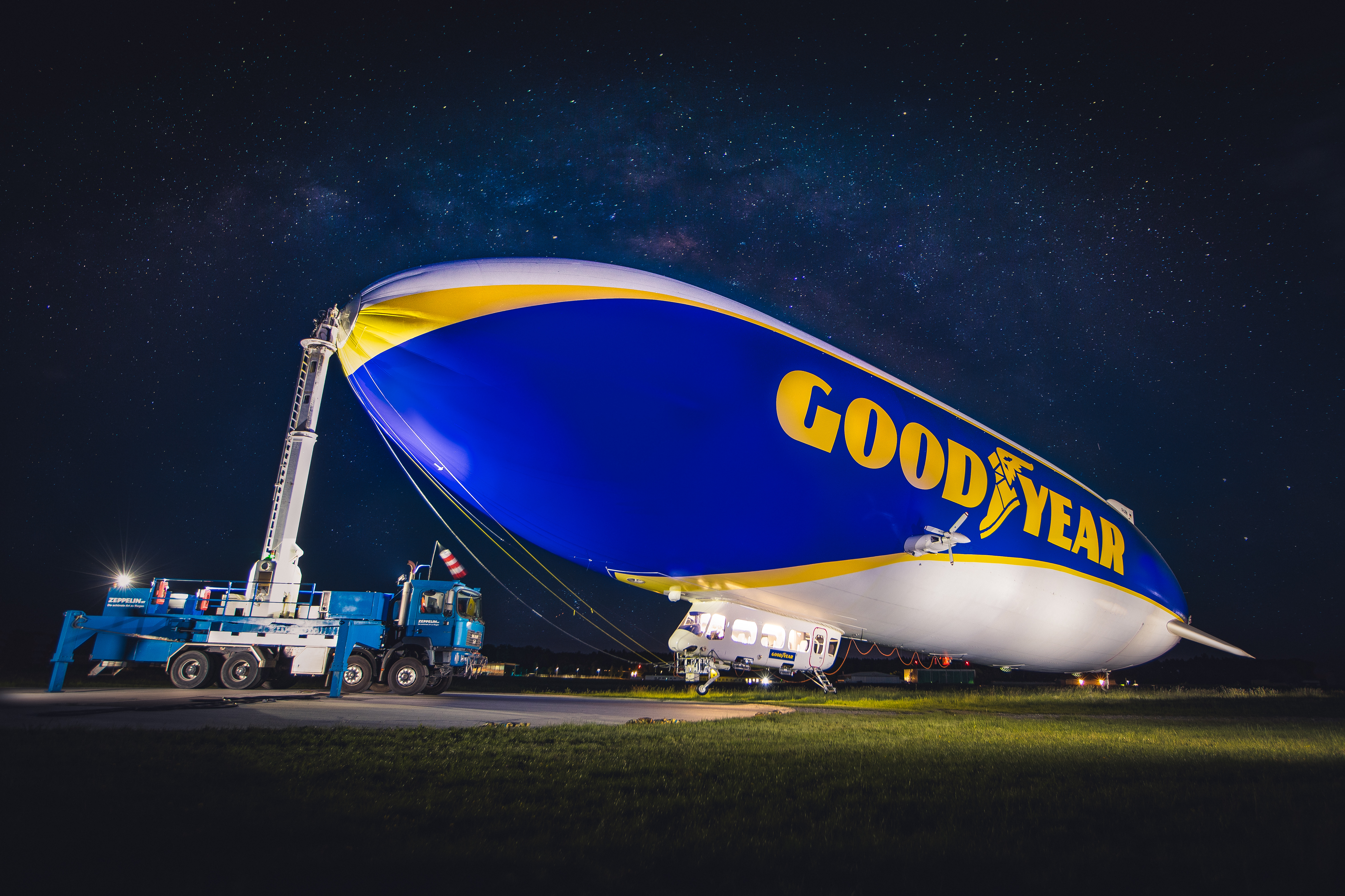 Official Goodyear photograph of the Goodyear blimp on the ground at night.