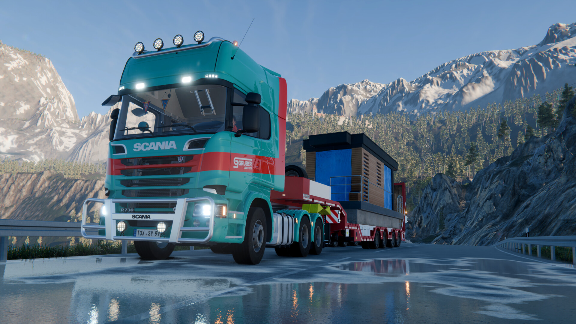 Official Heavy Cargo screenshot showing a Scania heavy-haul truck carrying a large load through a mountain road.