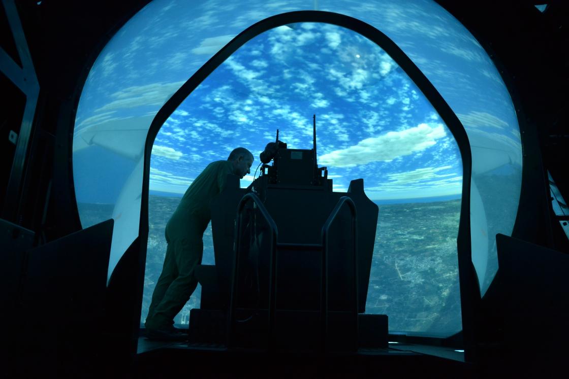 Official Leonardo photograph showing a pilot-training simulator with a projected flight environment.
